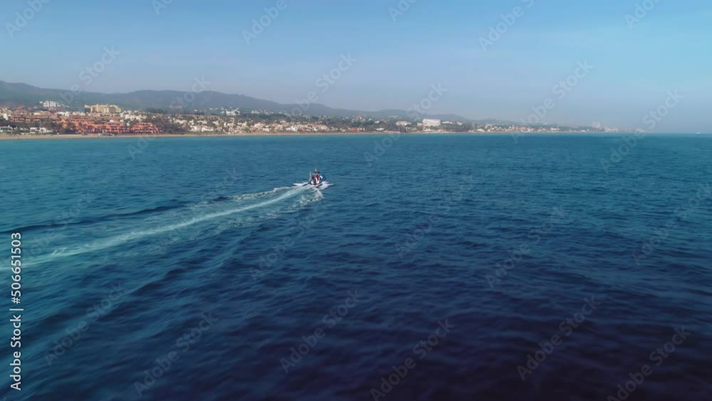 Aerial drone flying over a motorboat near the Spanish coastline Aerial drone flying over a motorboat near the Spanish coastline