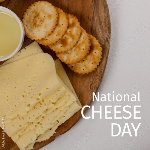 Digital composite of national cheese day text with cheese and biscuits, copy space