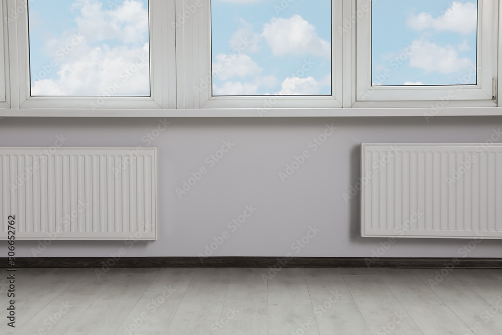 Fototapeta premium Modern office with window and radiators. Interior design