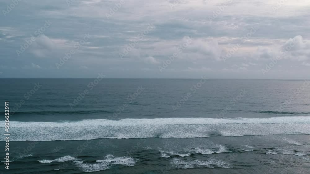 Ocean beach water waves against cloudy sky. Ocean beach water waves against cloudy sky.