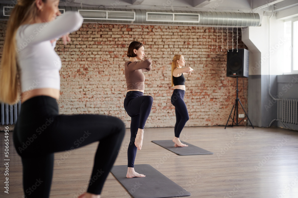 It's yoga time. European strong women spend time in yoga class before stretching exercises
