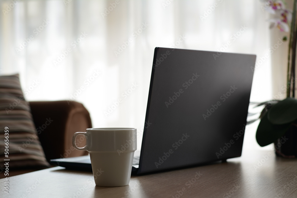 Ceramic cup and laptop on wooden table indoors. Good morning Ceramic cup and laptop on wooden table indoors. Good morning
