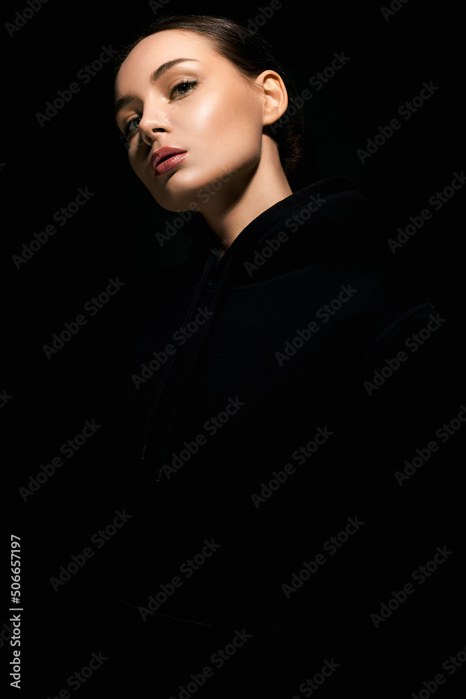 beautiful young woman in dark studio. pretty girl beautiful young woman in dark studio. pretty girl
