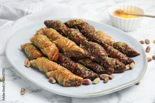 Delicious baklava with pistachio nuts on white marble table