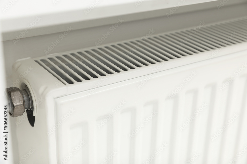 Closeup view of modern radiator. Central heating system