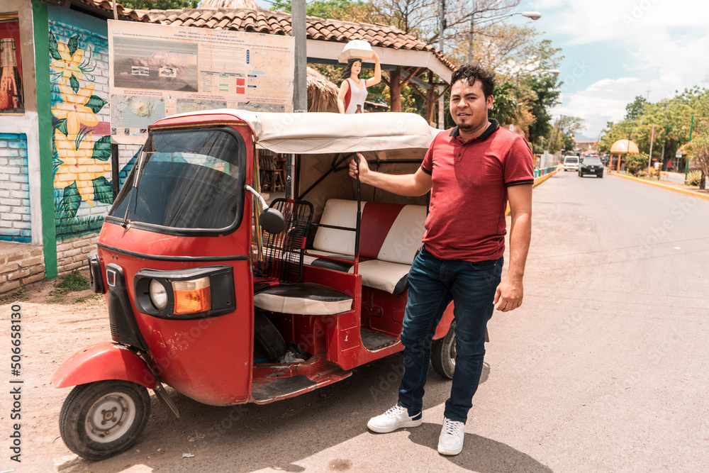 Motorcycle taxi driver in the municipality of La Paz Centro Nicaragua. Self-employed worker in his vehicle. Concept of transportation in towns Motorcycle taxi driver in the municipality of La Paz Centro Nicaragua. Self-employed worker in his vehicle. Concept of transportation in towns