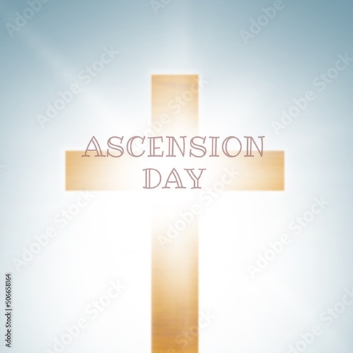 Ascension day text with cross over bright blue background, copy space