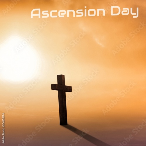 Ascension day text with cross against cloudy sky during sunset, copy space