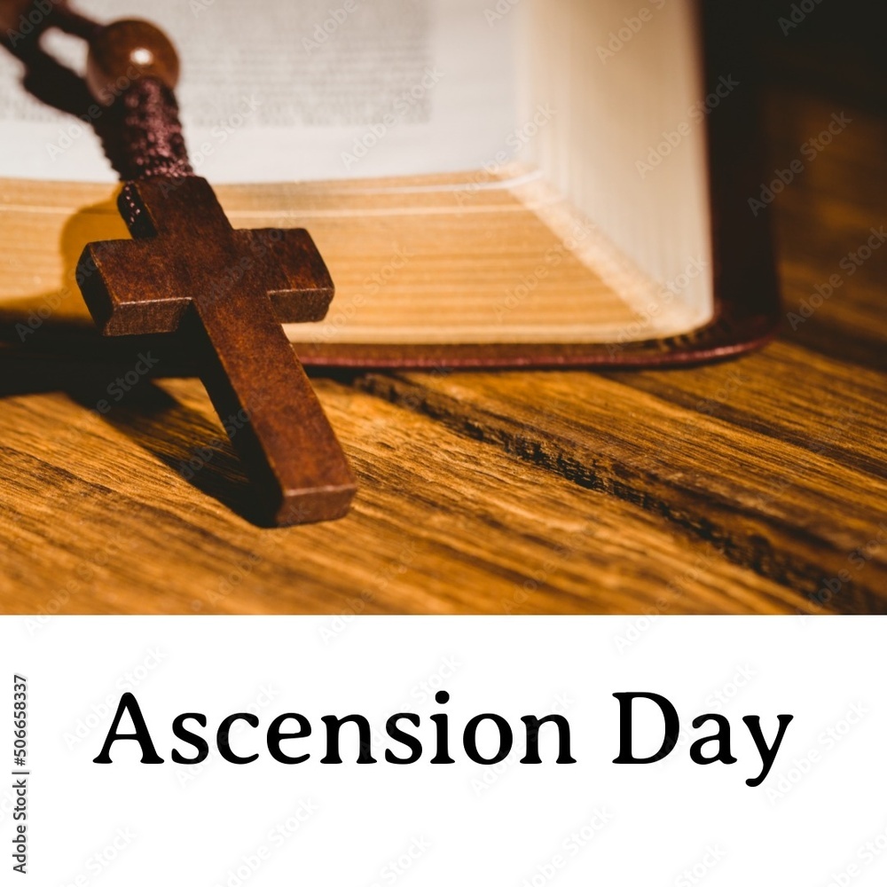Ascension day text with wooden cross on bible at table, copy space