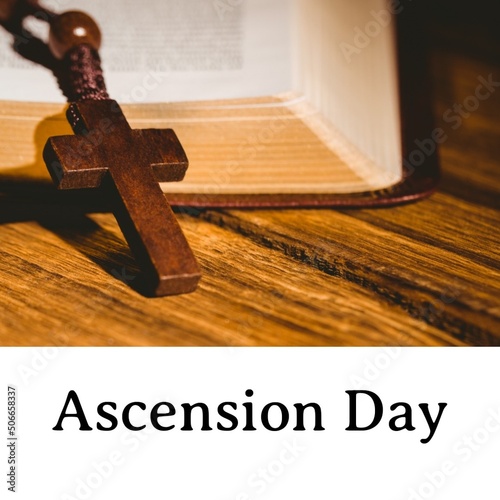 Ascension day text with wooden cross on bible at table, copy space