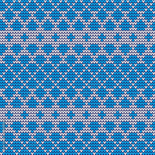 Knitted blue and white pattern. Geometric shapes triangles, rhombuses.