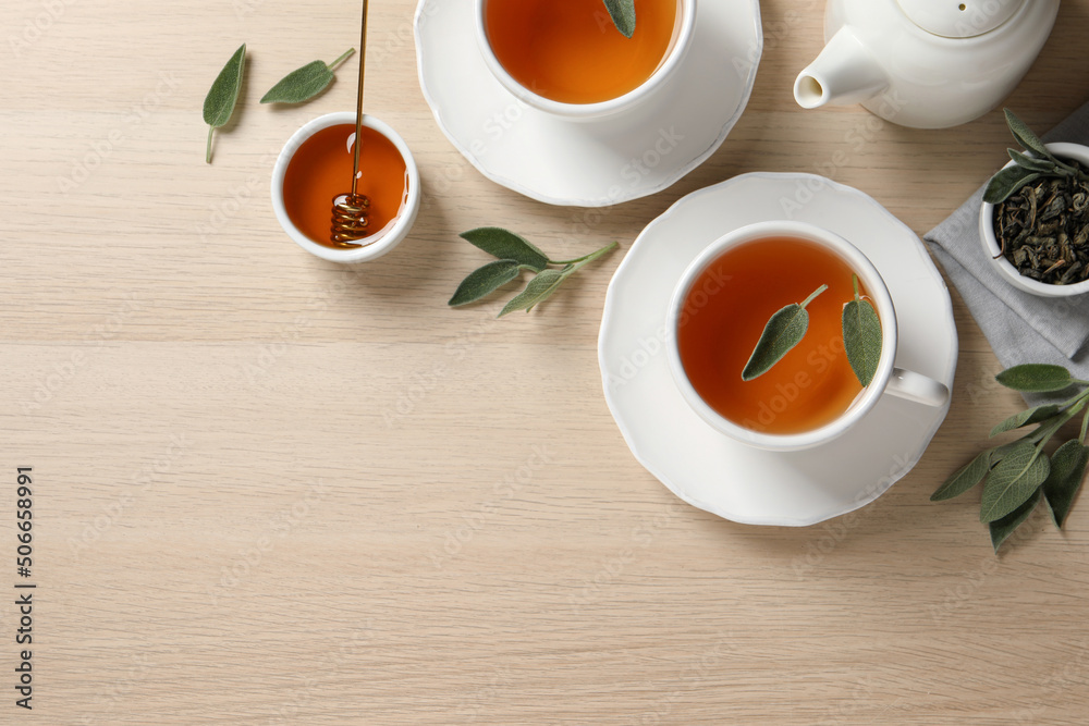 Flat lay composition with aromatic sage tea on wooden table. Space for text Flat lay composition with aromatic sage tea on wooden table. Space for text