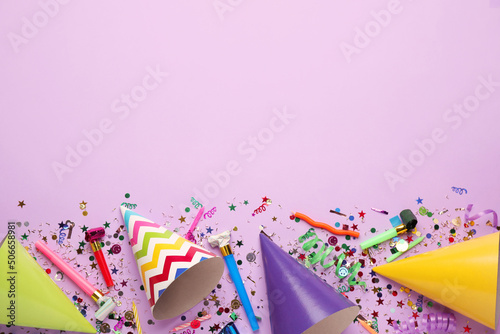 Beautiful flat lay composition with festive items on violet background, space for text. Surprise party concept