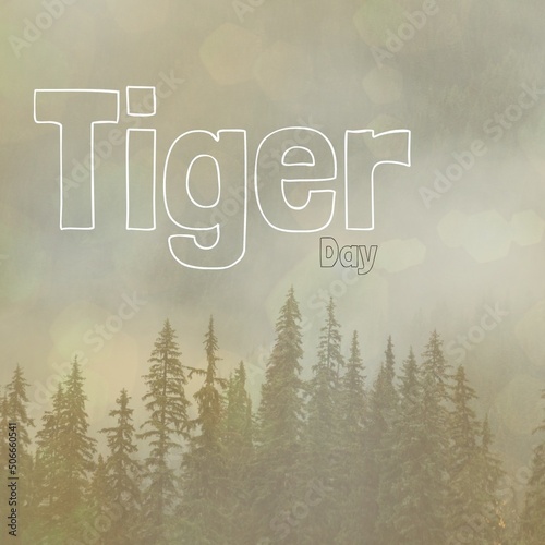 Illustrative image of tiger day text and pine trees growing in woodland against sky, copy space