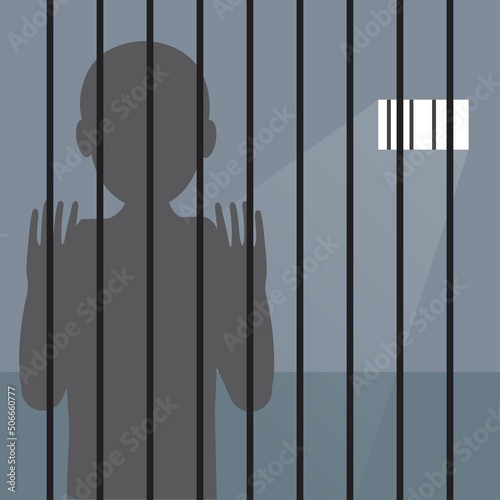 Silhouette of a prisoner inside a prison behind bars