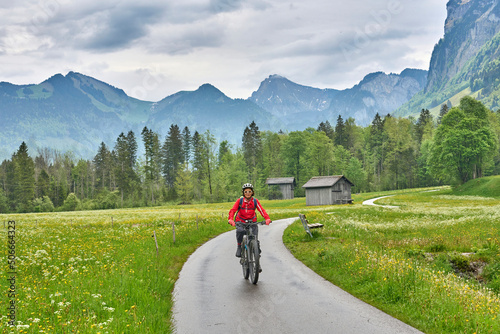 senior woman on electric mountain bike on the Bregenz Forest bicycle track up to Hochtannberg Pass, Vorarlberg, Austria  © Uwe
