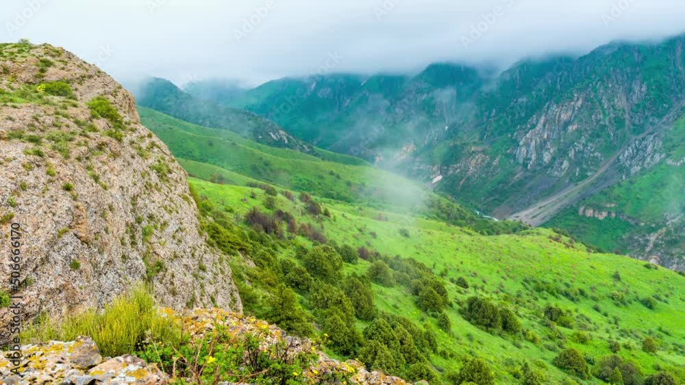 Thunderclouds hang low over the beautiful spring canyon Aksu Dzhabagly. Gentle calming landscape panorama for relaxation. formation of clouds in the mountains. Thunderclouds hang low over the beautiful spring canyon Aksu Dzhabagly. Gentle calming landscape panorama for relaxation. formation of clouds in the mountains.