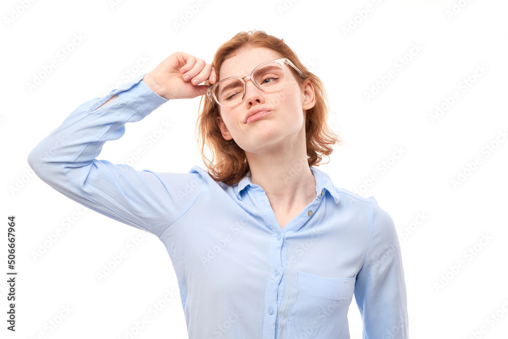 Smart redhead girl in business shirt and glasses touches head thinks doubts, makes decision isolated on white studio background Smart redhead girl in business shirt and glasses touches head thinks doubts, makes decision isolated on white studio background