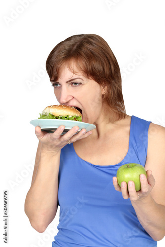 Portrait of young beautiful hungry woman eating burger. Diet concept.