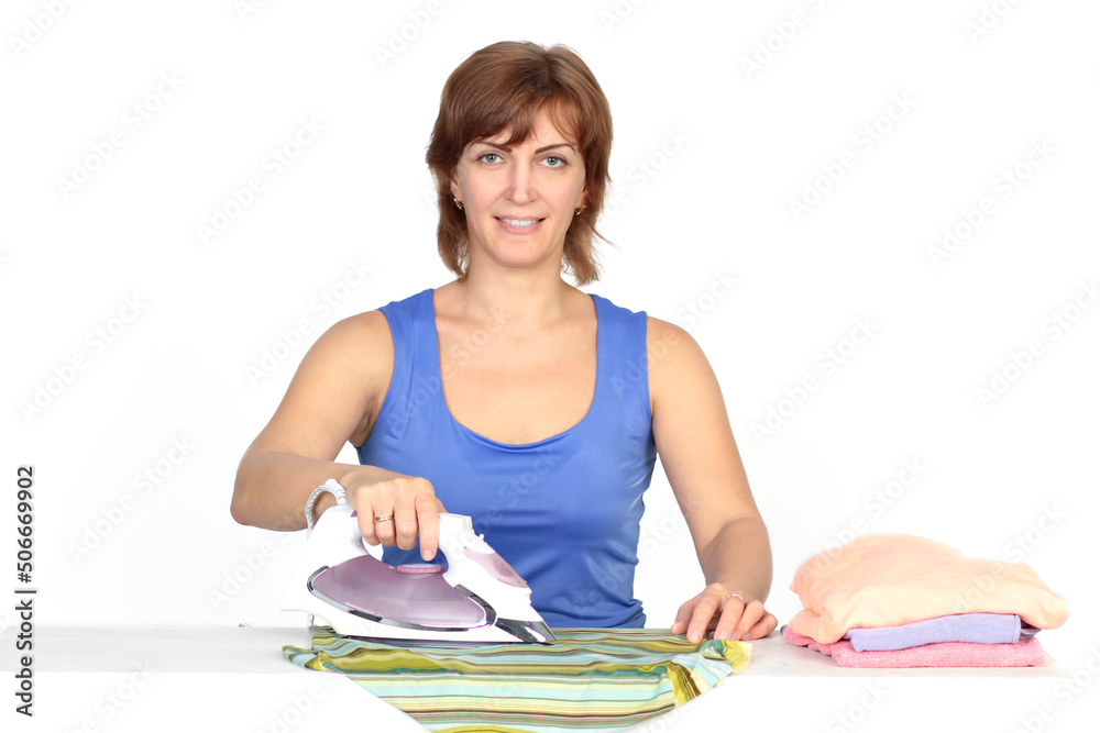 Young smiling woman is ironing a shirt with a shirt iron on white background. Young smiling woman is ironing a shirt with a shirt iron on white background.