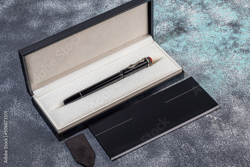 Fountain pen on a marble and gray background. Selective focus.