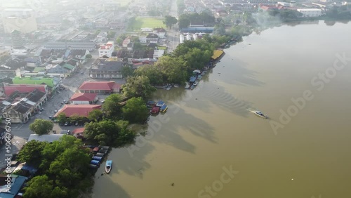 Aerial view passenger boats leave Teluk Intan jetty in misty morning photo