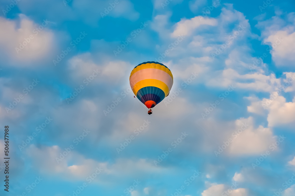 Obraz premium Balloon on the background of blue sky with white clouds in summer