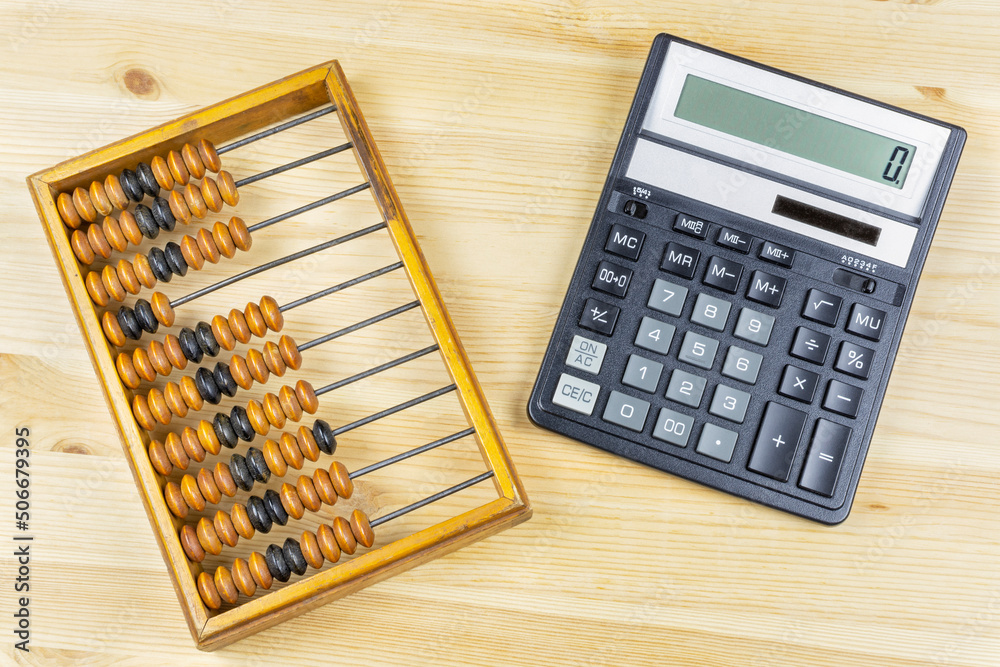 Old antique wooden abacus and modern calculator close-up. Progress in accounting, business, account. Old antique wooden abacus and modern calculator close-up. Progress in accounting, business, account.