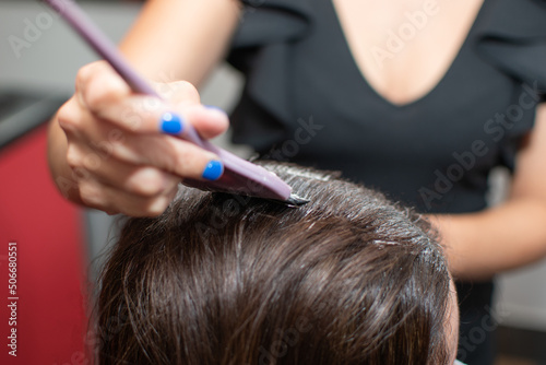 hairdresser cutting hair with scissors
