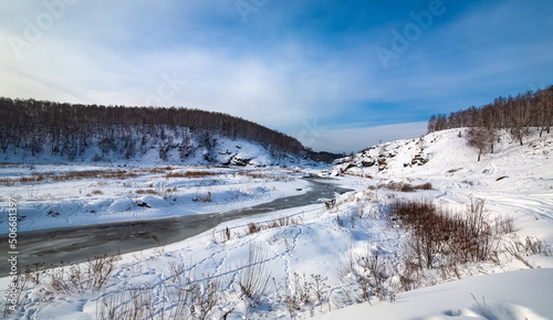 Fototapeta Naklejka Na Ścianę i Meble -  Winter landscape with trees and sky from the high rocky river bank