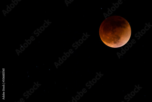 Moon and stars in the sky during the total moon eclipse May 15, 2022 photo