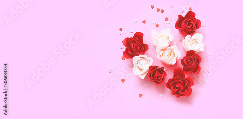Festive concept from rosebuds on pink background. Template mock up of greeting card or text design. Close-up