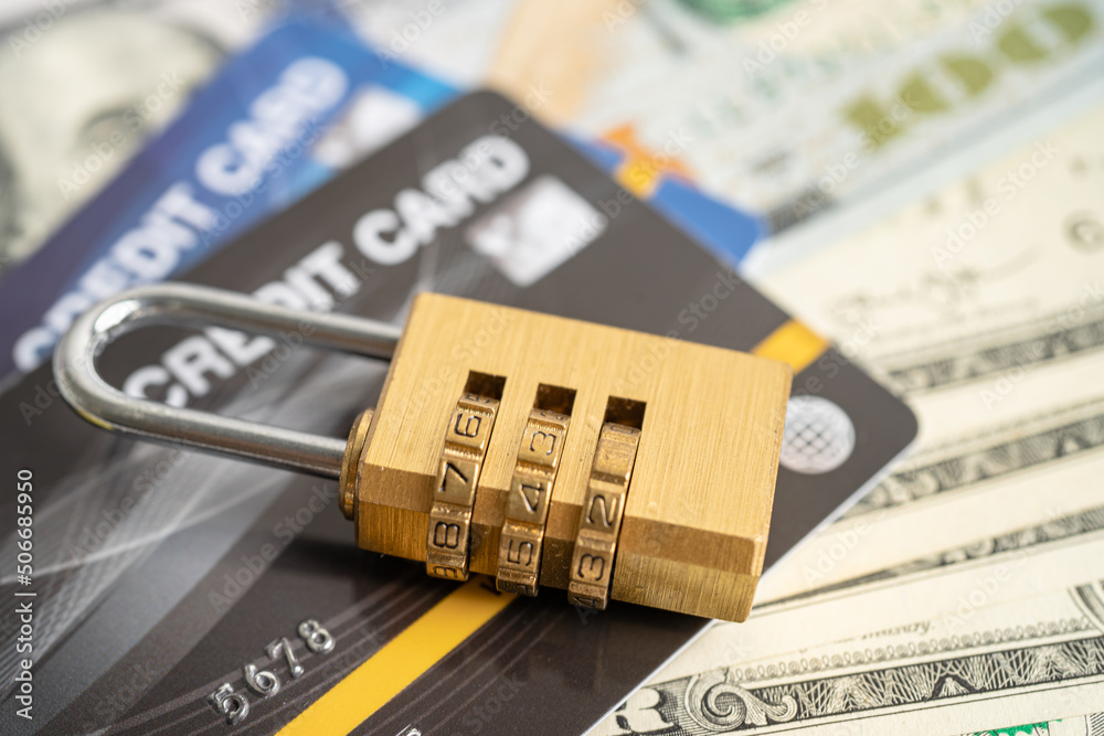 Credit card with password key lock security on US dollar background. Credit card with password key lock security on US dollar background.