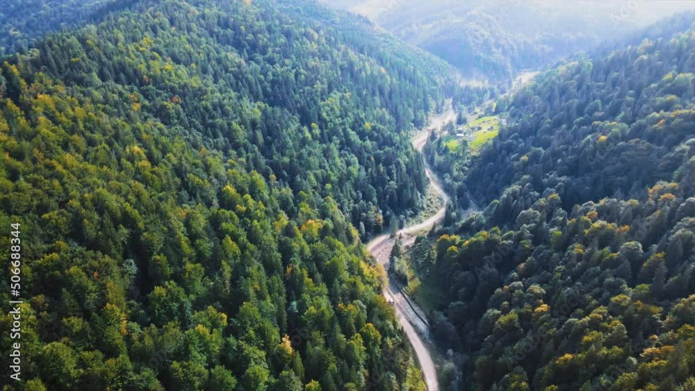 Amazing top aerial view of off road trail in mountains. Mountains in Ukraine. Trees. Beautiful nature. Slow motion Amazing top aerial view of off road trail in mountains. Mountains in Ukraine. Trees. Beautiful nature. Slow motion