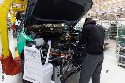 Car bodies are on assembly line. Factory for production of cars. Modern automotive industry. A car being checked before being painted in a high-tech enterprise