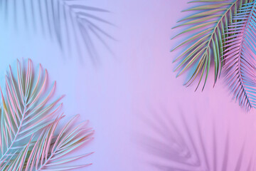 Creative layout made of tropical leaves and shadows in vibrant gradient holographic neon colors. Flat lay. Minimal surreal summer background with copy space. Border arrangement.