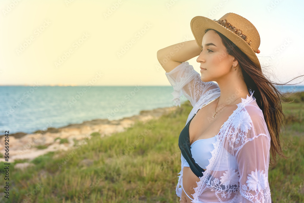 Happy traveller woman in white dress enjoys her tropical beach vacation. High quality photo