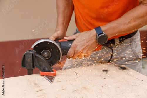 A man in his yard is engaged in locksmith work. Hobby, in a home workshop.