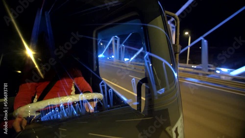Exterior on Truck Driver rides at night crossing bridge with colorful lights