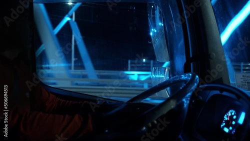 Interior Truck Driver rides at night crossing bridge with colorful lights