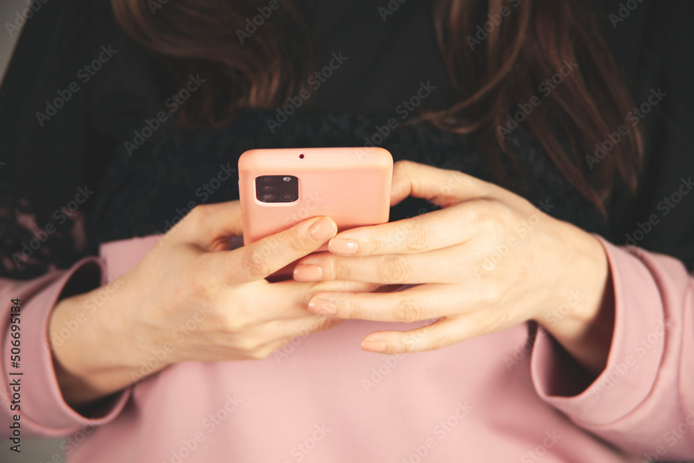 woman hand holding smart phone on gray background woman hand holding smart phone on gray background