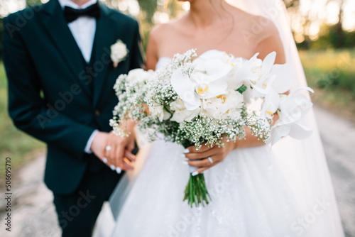 white bride's bouquet in the hands of the bride