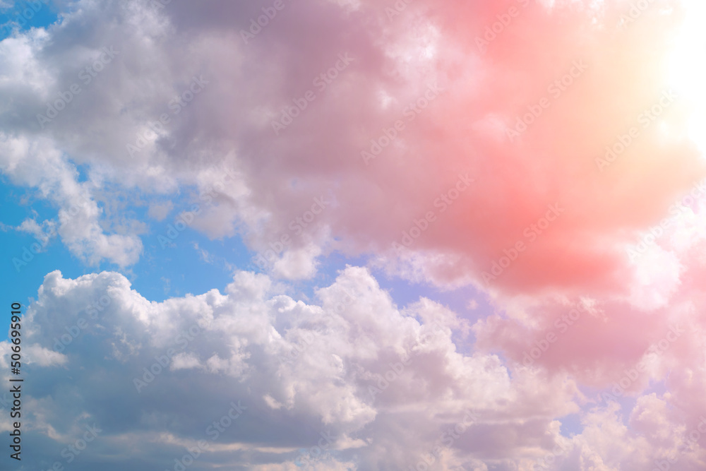 Bright pink, summer clouds against the blue sky.