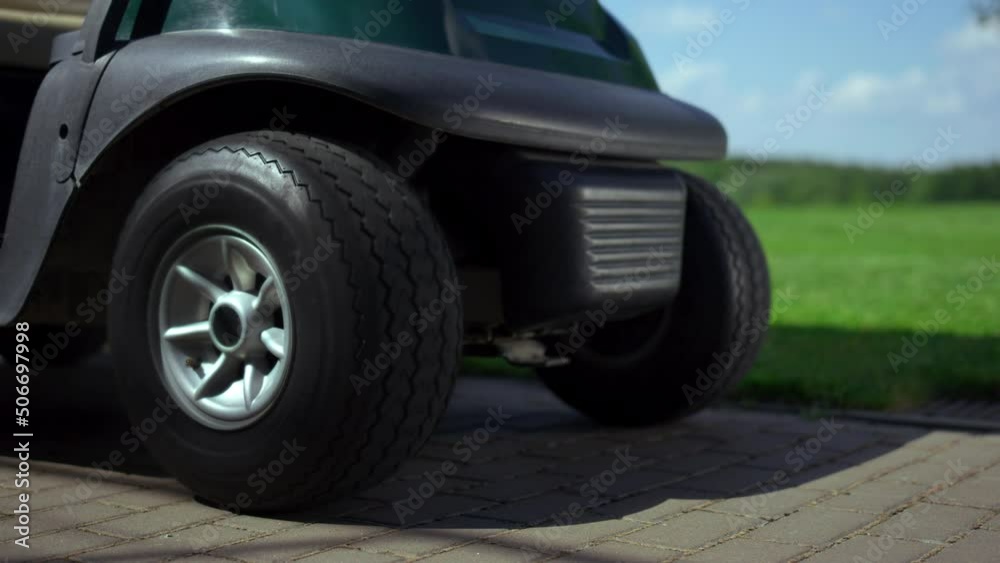 Professional golfing cart wheels at golf club road. Sport buggy car at summer. Professional golfing cart wheels at golf club road. Sport buggy car at summer.
