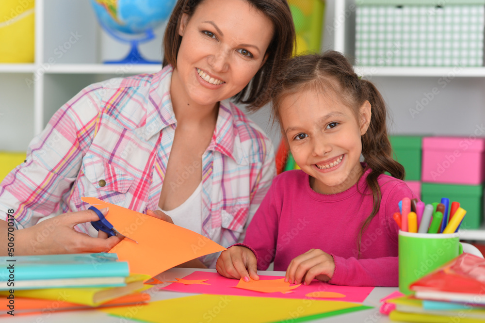 Mother teaches her cute daughter to do craft items Mother teaches her cute daughter to do craft items