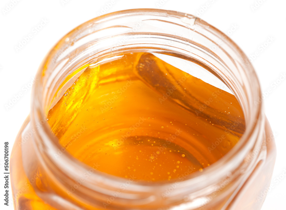 glass honey jar isolated on white background glass honey jar isolated on white background
