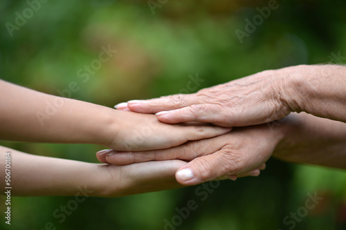 granddaughter and grandmother holding hands outdoors