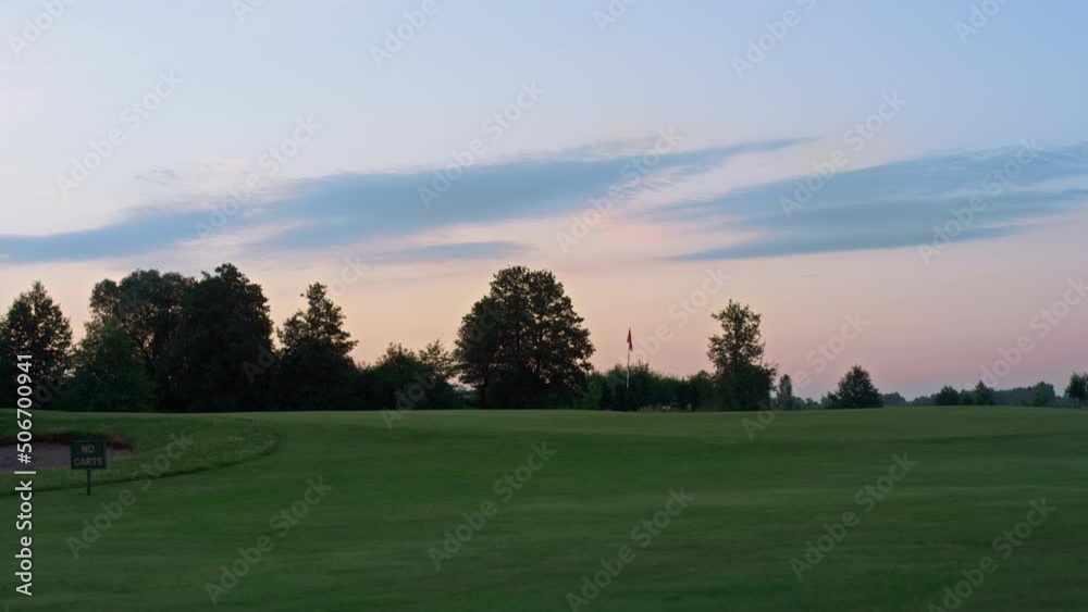 Beautiful sunset golf course park. Sun setting on dawn park landscape in evening Beautiful sunset golf course park. Sun setting on dawn park landscape in evening