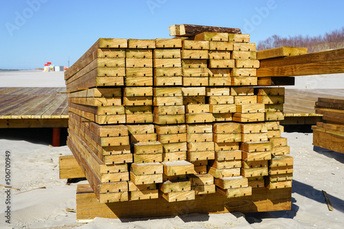 Stacked brown pine wood outdoor decking boards for sandy beach infrastructure improvement