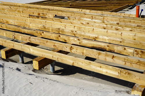 construction of a pine wooden board terrace on a sandy beach